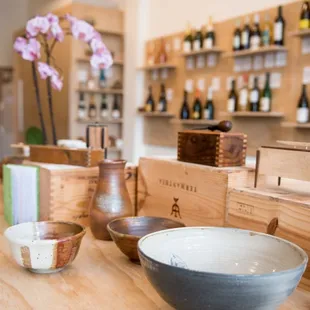a wooden table with bowls and bottles