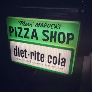 The original sign still hangs today. Established 1962