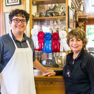 a man and woman standing in front of a counter