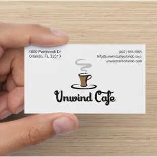 a hand holding a business card