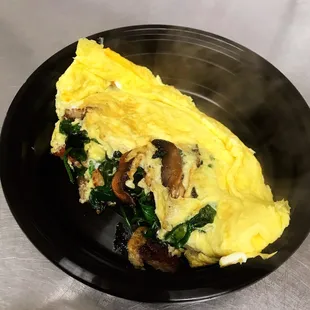 an omelet with spinach and mushrooms