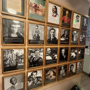 a wall of framed photographs