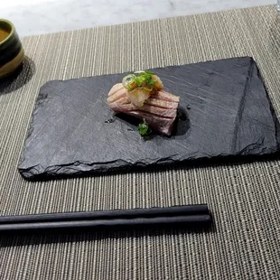a plate of food with chopsticks