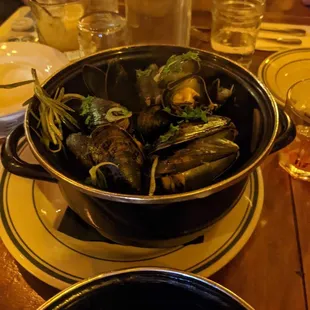 a bowl of mussels on a table