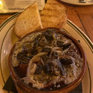 a bowl of soup and bread on a plate