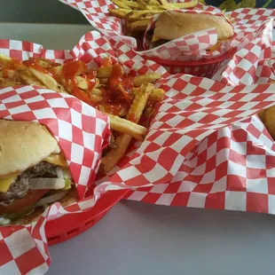 three burgers and onion rings