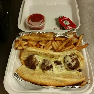 Meatball hoagie with fries. Comes with salt, ketchup, and cup of sauce.