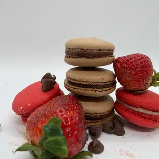 a stack of chocolate macarons and a strawberry