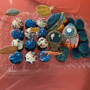 a tray of space themed cupcakes