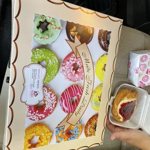 a person holding a box of doughnuts