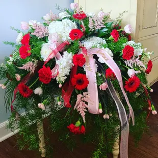 Deluxe Casket spray with gorgeous red gerbers.