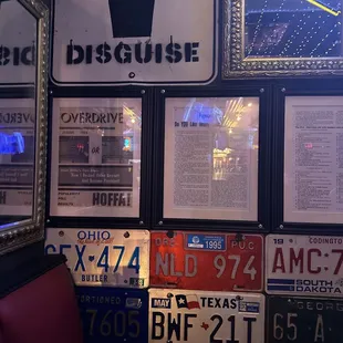 a number of license plates on a wall