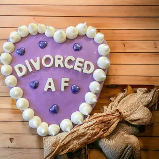 a heart shaped cake with the word divorced af