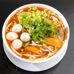 a bowl of soup with noodles and vegetables