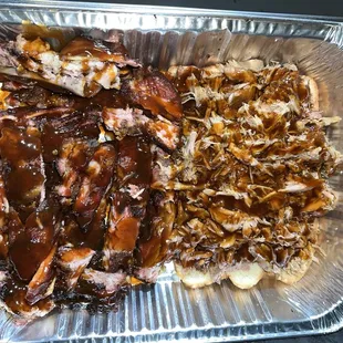 a tray of ribs, potatoes, and gravy