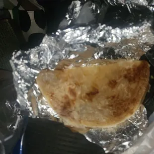 a piece of food wrapped in tin foil