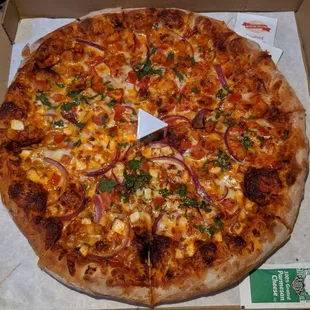 Half butter chicken, half butter paneer pizza