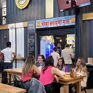 people sitting at tables in a restaurant