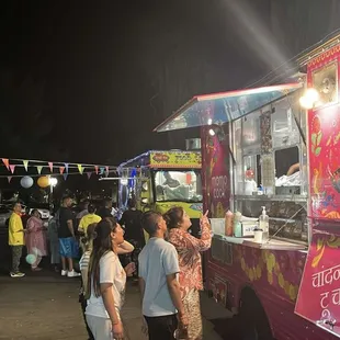 Well lit and lively food truck at 9pm on a Thursday night