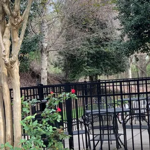 a table and chairs behind a fence