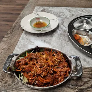 Spicy pork, seated on a bed of mixed greens. Lots of pork and tastes good.