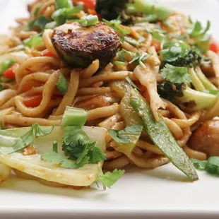 a plate of noodles with meat and vegetables