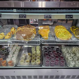 a variety of pastries in a display case