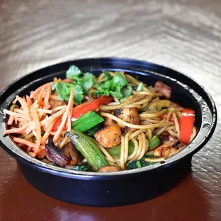 a bowl of noodles and vegetables