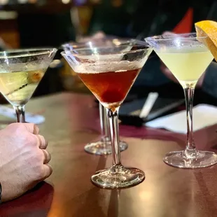 three cocktails on a table