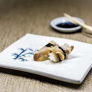a plate of food with chopsticks