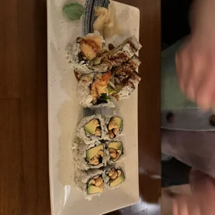 a plate of sushi with chopsticks
