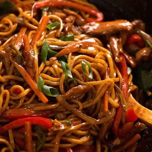 a stir fry with noodles and vegetables