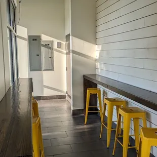 a row of yellow stools in a restaurant