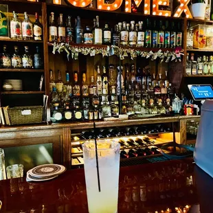 a glass of lemonade on a bar