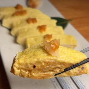 a fork holding a piece of food