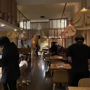 a busy restaurant with people sitting at tables