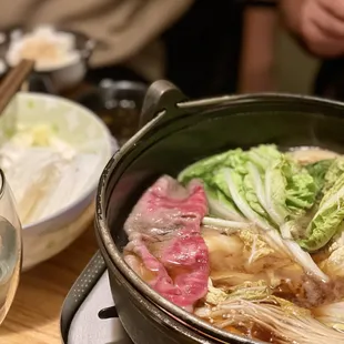 a pot of soup with meat and vegetables