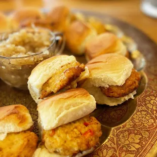 a plate of crab cakes with a side of sauerkraut