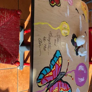 a butterfly on a wooden table