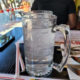 a glass of water and a menu