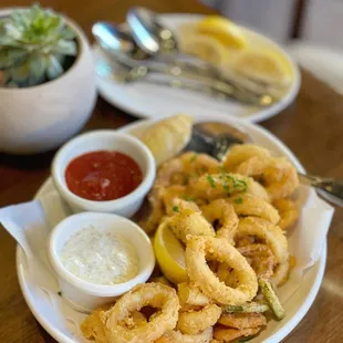 a plate of fried calamails and dipping sauce