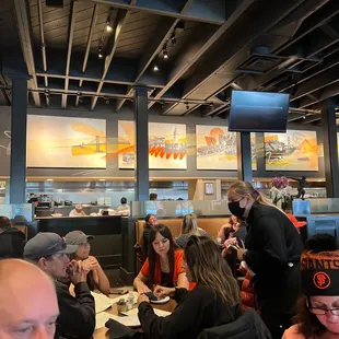 a large group of people eating at a restaurant