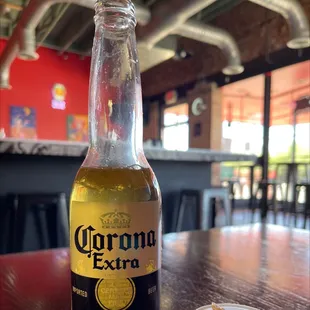 a bottle of corona extra on a table