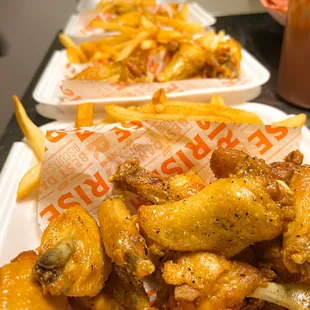 a tray of chicken wings and french fries