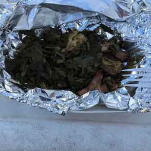 a plate of food wrapped in tin foil