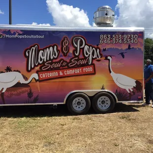 a man standing in front of a trailer