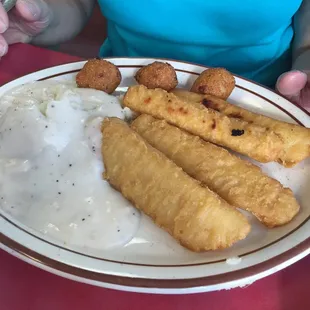 Breaded cod, mashed potatoes, and hushpuppies.