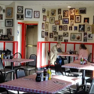 Mick brings coffee refills to a couple dining on the other side of the dining room.  Note the many pictures of moms that decorate the wall.