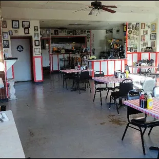 The dining room is large, with high tables around the walls, and lower tables in the center.