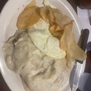 Chicken fried chicken with the fried potatoes and over easy eggs